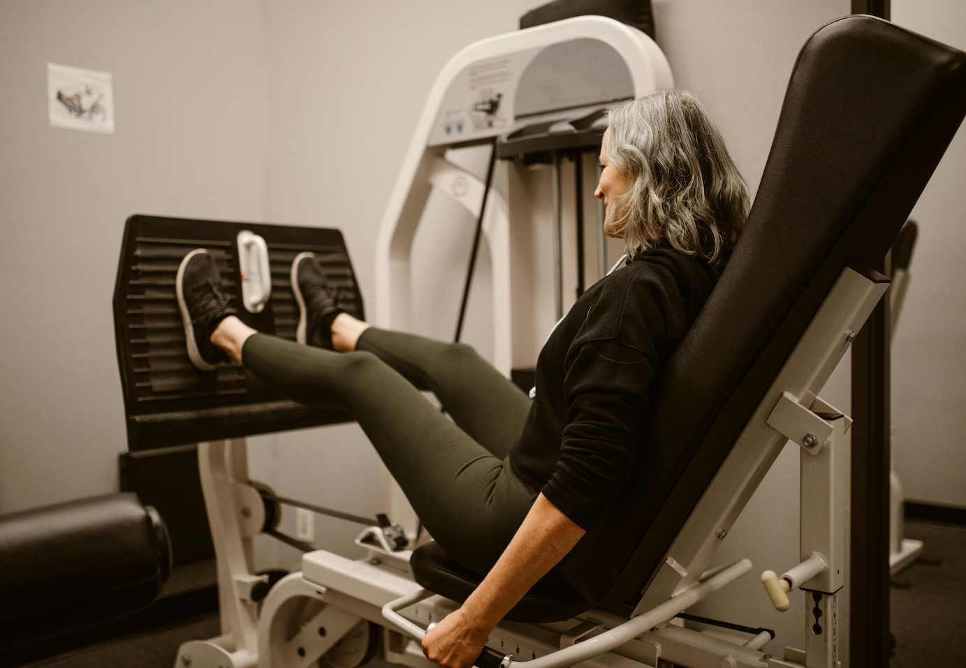 Person using a leg press machine in a gym setting